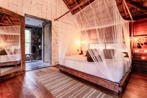a bedroom with a bed with mosquito netting at Vida Silvestre in Tulum