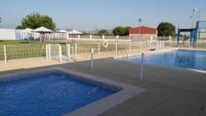 an empty swimming pool with a fence around it at Casa rural Bisimbre in Bisimbre