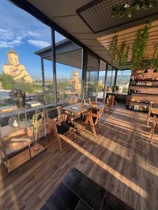 a patio with a table and chairs on a building at Hotel Livin in Tbilisi City