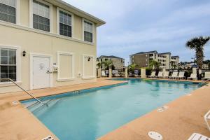 a swimming pool with blue water in front of a building at BeauView in Little River