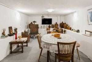 a room with a table and chairs and a tv at House Matenda house in Solin