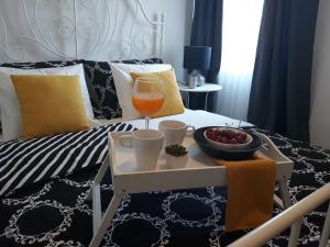 a bed with a tray with a glass of wine and a tray of fruit at House Matenda house in Solin +23 photos