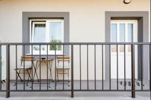 an apartment balcony with a table and chairs at House Matenda house in Solin