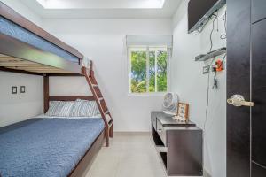 a bedroom with two bunk beds and a desk at Jacarandas 4 in Tamarindo +24 photos