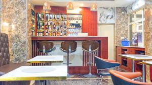 a bar with chairs and a counter in a restaurant at Sugarland Hotel and Suite in Ikeja