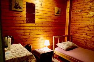 a room with a wooden cabin with a bed and a table at U6 Schöpfwerk Hostel 1 in Vienna