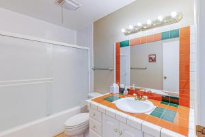 a bathroom with a sink and a toilet and a mirror at Cozy Hideout in Scottsdale