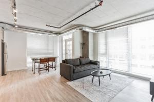 a living room with a couch and a table at DT Delight Downtown Living Two-Bedroom Endless Access in Cleveland