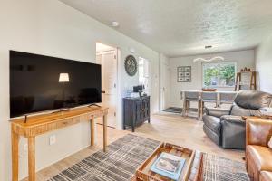 a living room with a large flat screen tv at Cozy Meyers Lake Townhome Near Hall of Fame! in Canton