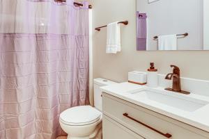 a bathroom with a toilet and a sink at Cozy Meyers Lake Townhome Near Hall of Fame! in Canton +16 photos