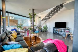 a living room with a couch and a staircase at House Gallery 10 in Tijoco de Abajo
