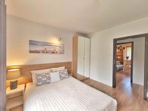 a bedroom with a bed and a mirror at Apartament Garden- parking, ogródek, cicha okolica in Pruszcz Gdański