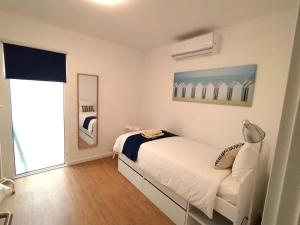 En eller flere senge i et værelse på Porto Santo - Pedras Pretas Beach House