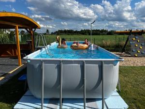 a group of people in a pool in a playground at Domki Masztowa Przystań in Gąski