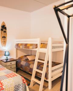 a bedroom with two bunk beds and a ladder at Costanova Surfhouse in Ílhavo +113 photos