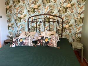 a bed with pillows on it in a bedroom at La maison des Dames Marie in Coursan