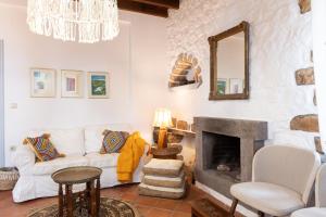 a living room with a couch and a fireplace at Blue Vista Patmos in Skala
