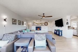 a living room with a blue couch and a fireplace at Driftwood in Cannon Beach