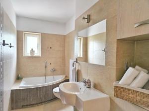 a bathroom with a sink and a tub and a toilet at Apartament Garden- parking, ogródek, cicha okolica in Pruszcz Gdański +26 photos