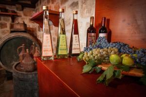 a bunch of bottles of wine sitting on a table at Apartments & Rooms Konoba Tomić in Gornji Humac