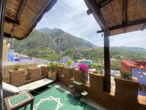 a balcony with a view of a mountain at Riad Gharnata in Chefchaouen