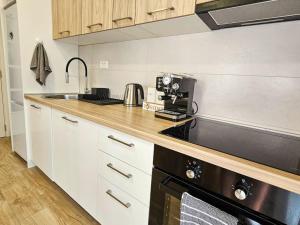 a kitchen with a sink and a stove top oven at Blanc in Podgorica +14 photos