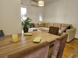 a living room with a table and a couch at Blanc in Podgorica