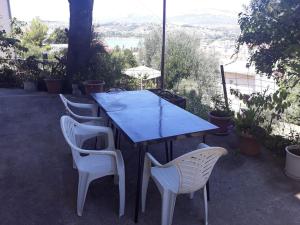 a table and chairs with a table and a view at Apartment in Podstrana, 5 km from Split in Podstrana