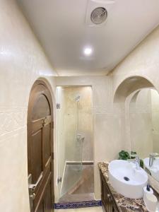 a bathroom with a sink and a shower at Riad Gharnata in Chefchaouen +66 photos