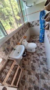 a bathroom with a sink and a toilet at Casa Gaia Paradise in Mompiche