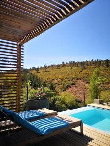 a patio with a hammock and a swimming pool at Em Xisto - Casas de Montanha - Casa T0 in Góis +25 photos