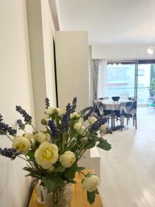 a vase of flowers on a table in a room at Residence Mona Lisa bord de mer Menton in Menton