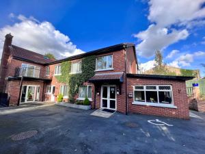 a brick house with a parking lot in front of it at Ashfield Bed & Breakfast in Belfast