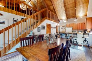 an open kitchen and dining room with a wooden table and chairs at Selah Retreat in Ronald