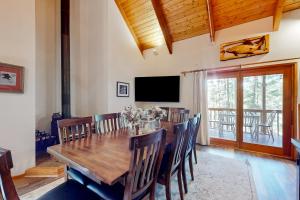 a dining room with a large wooden table and chairs at Selah Retreat in Ronald