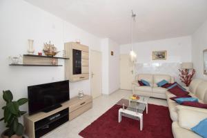 a living room with a couch and a tv at Corcyra Nigra Apartment 2 in Blato