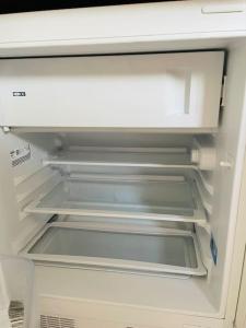 an empty refrigerator with its door open and itsartmentsearch at Studio-Apartment mit Balkon in Dresden