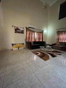a living room with a couch and a table at Chez nous house in Accra