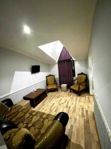 a room with a bed and a couch and a table at B&B Europa Hotel in Kutaisi