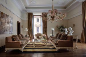 un soggiorno con 2 divani e un lampadario a braccio di Anantara Palazzo Naiadi Rome Hotel - A Leading Hotel of the World a Roma