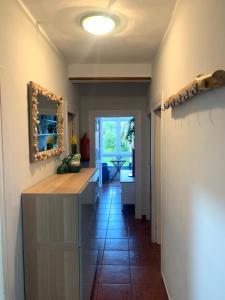a hallway with a counter and a mirror on the wall at La casita de Kalani in Comillas