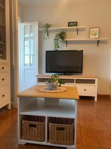 a living room with a tv and a coffee table at La casita de Kalani in Comillas