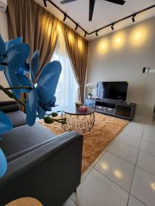 a living room with a couch and a tv at Youth City in Nilai
