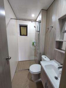 a bathroom with a toilet and a shower and a sink at Youth City in Nilai