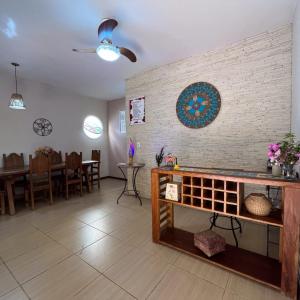 a living room with a table and a dining room at Pousada das Flores in Conservatória