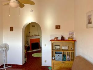 a living room with an archway and a fireplace at Casa David in Castelo de Vide
