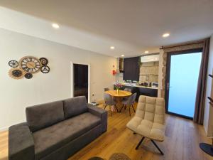 a living room with a couch and a table at O Sítio do Avô in Amarante