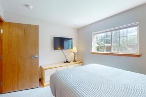 a bedroom with a bed and a flat screen tv at Aspen Suites 505: Enchantment Abode in Leavenworth +29 photos
