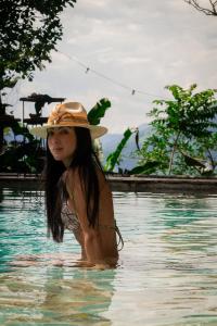 een jong meisje met een hoed in het water bij Cerro Tusa Springs in Venecia
