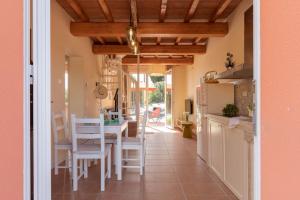 a kitchen and dining room with a table and chairs at Casa Melatina ToscanaOneHH in Riparbella